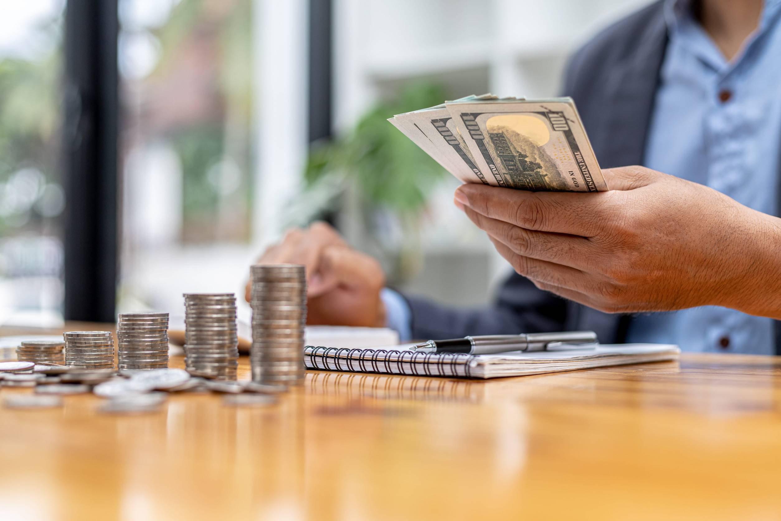 A Man Is Counting His Salary Dollars To Separate Expenses