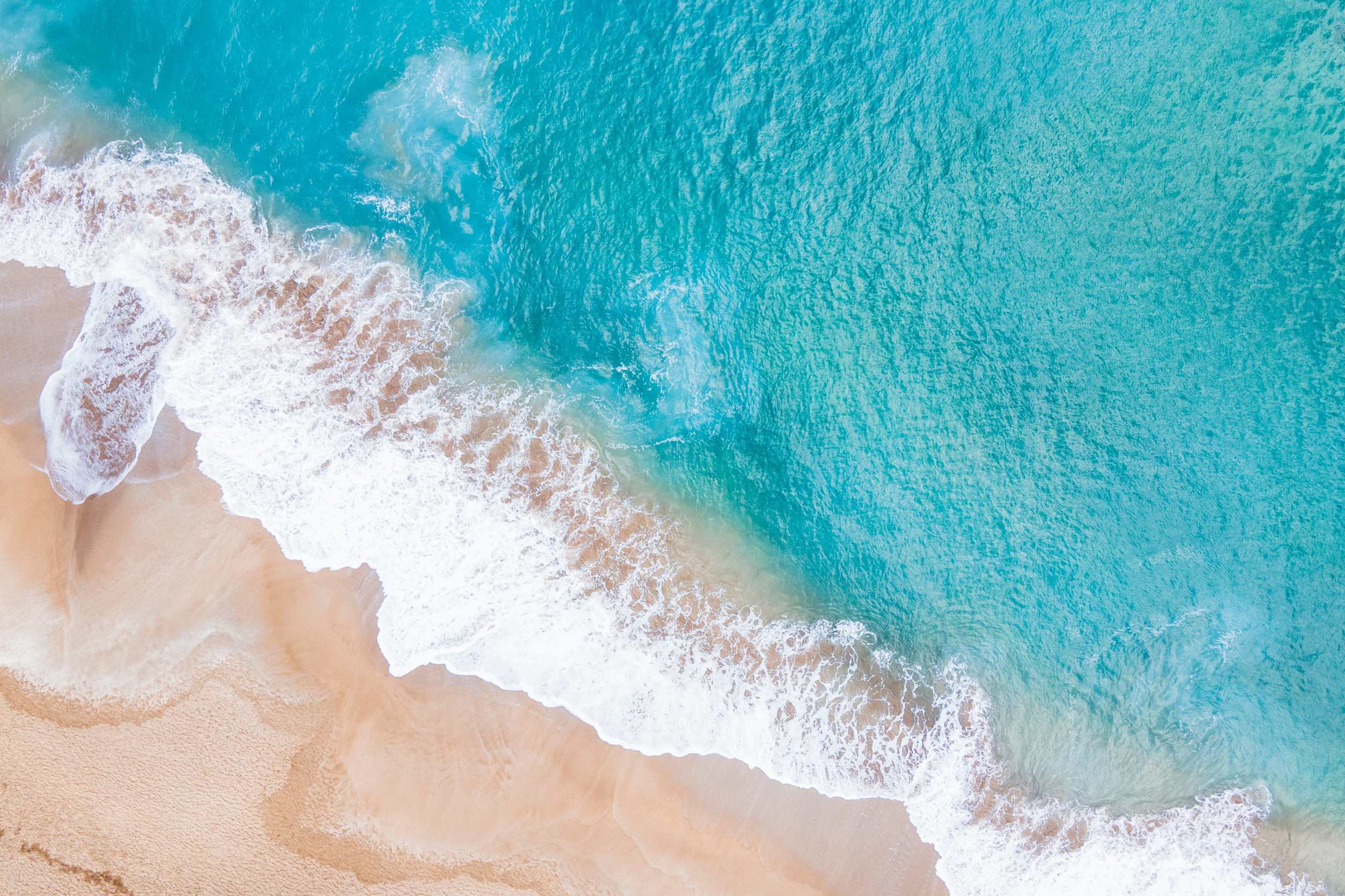 A Stunning View Of The Ocean Waves From The Top
