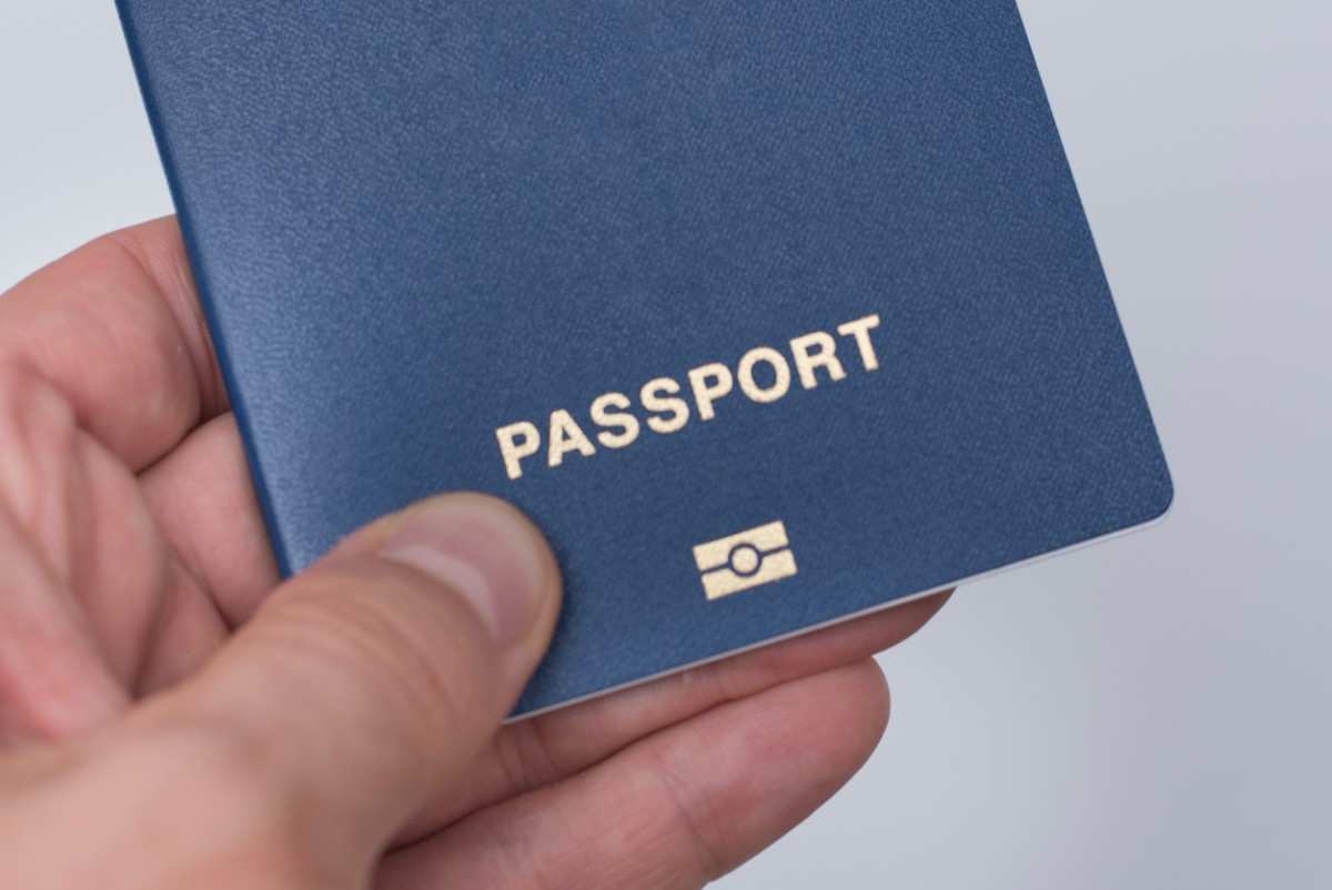 Blue Passport In A Mans Hand