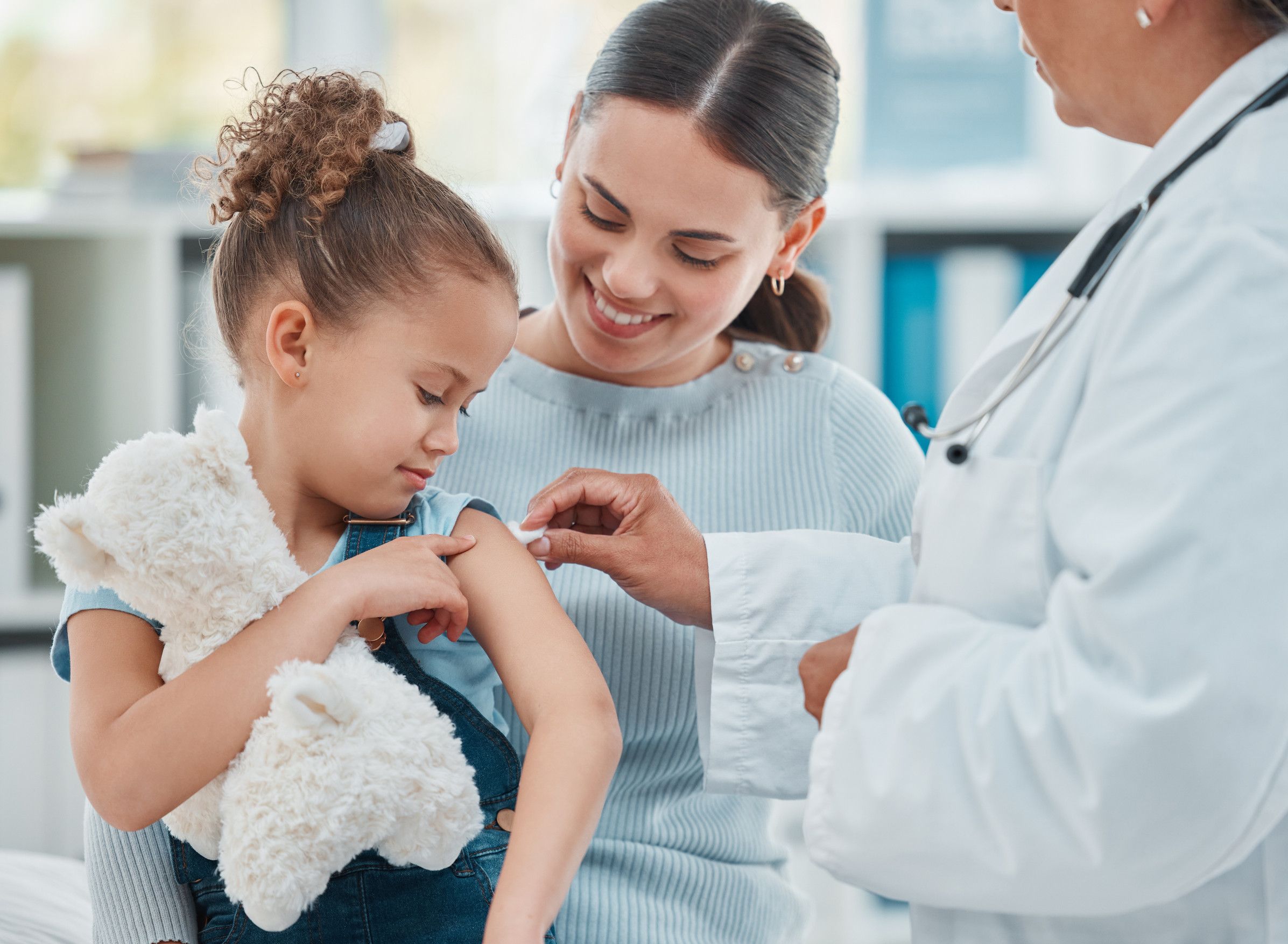 Doctor giving vaccine to young girl
