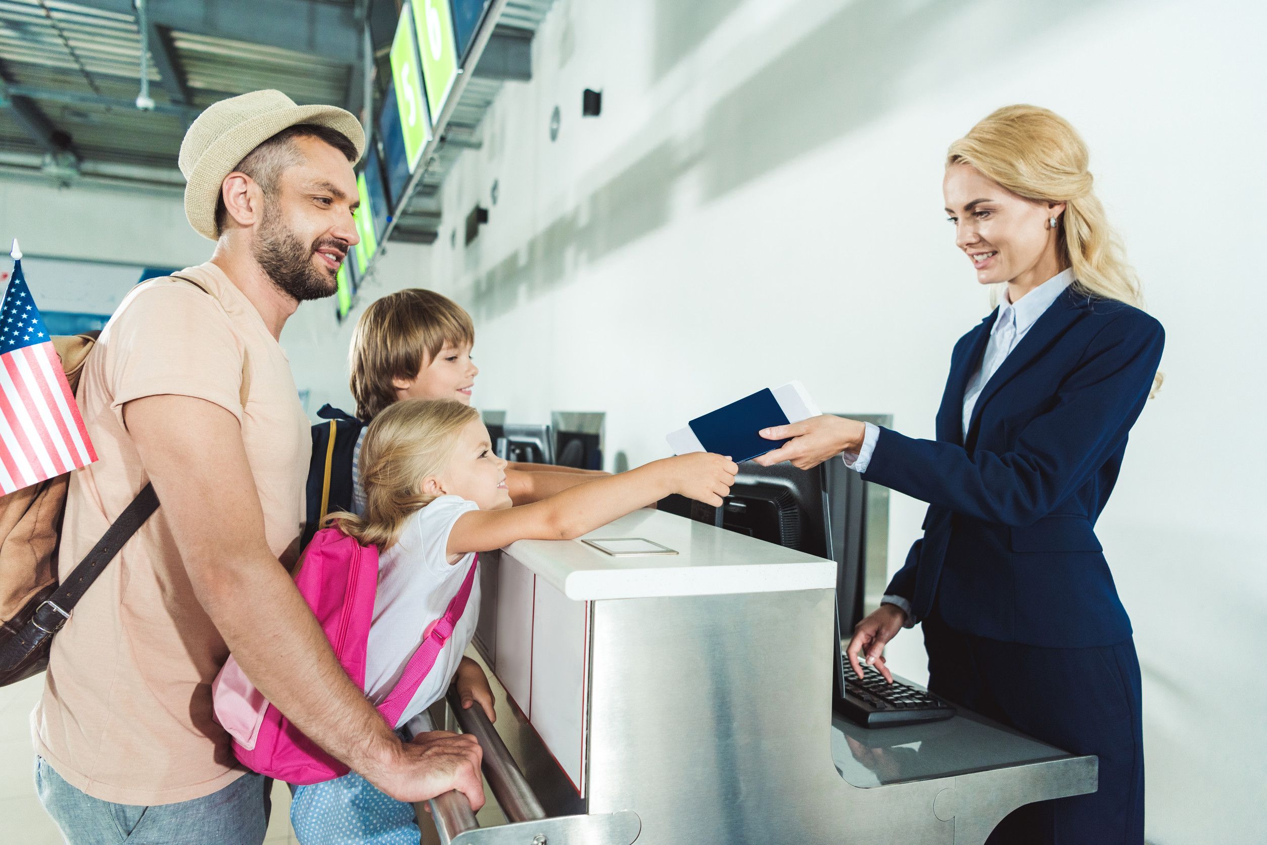 Family checking in at airport counter
