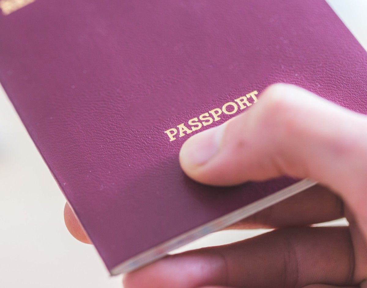 Fingers Holding A Passport