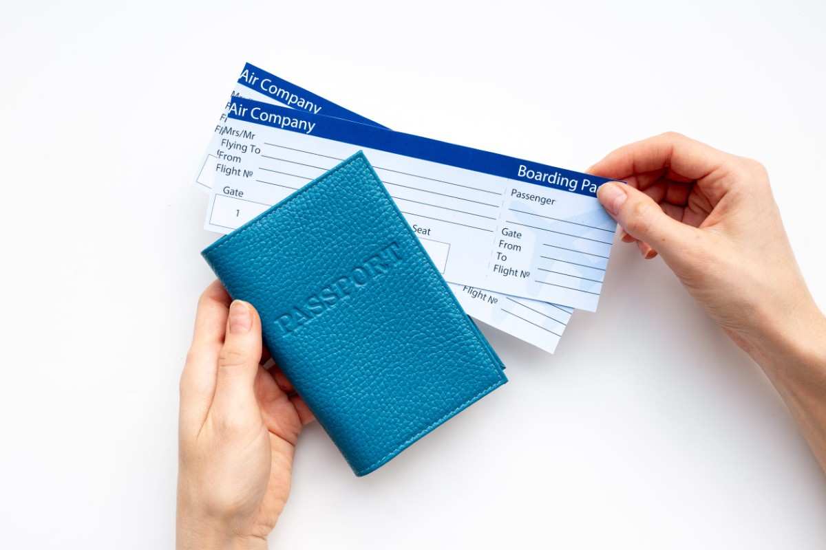 Hand Holding Passport With Air Tickets