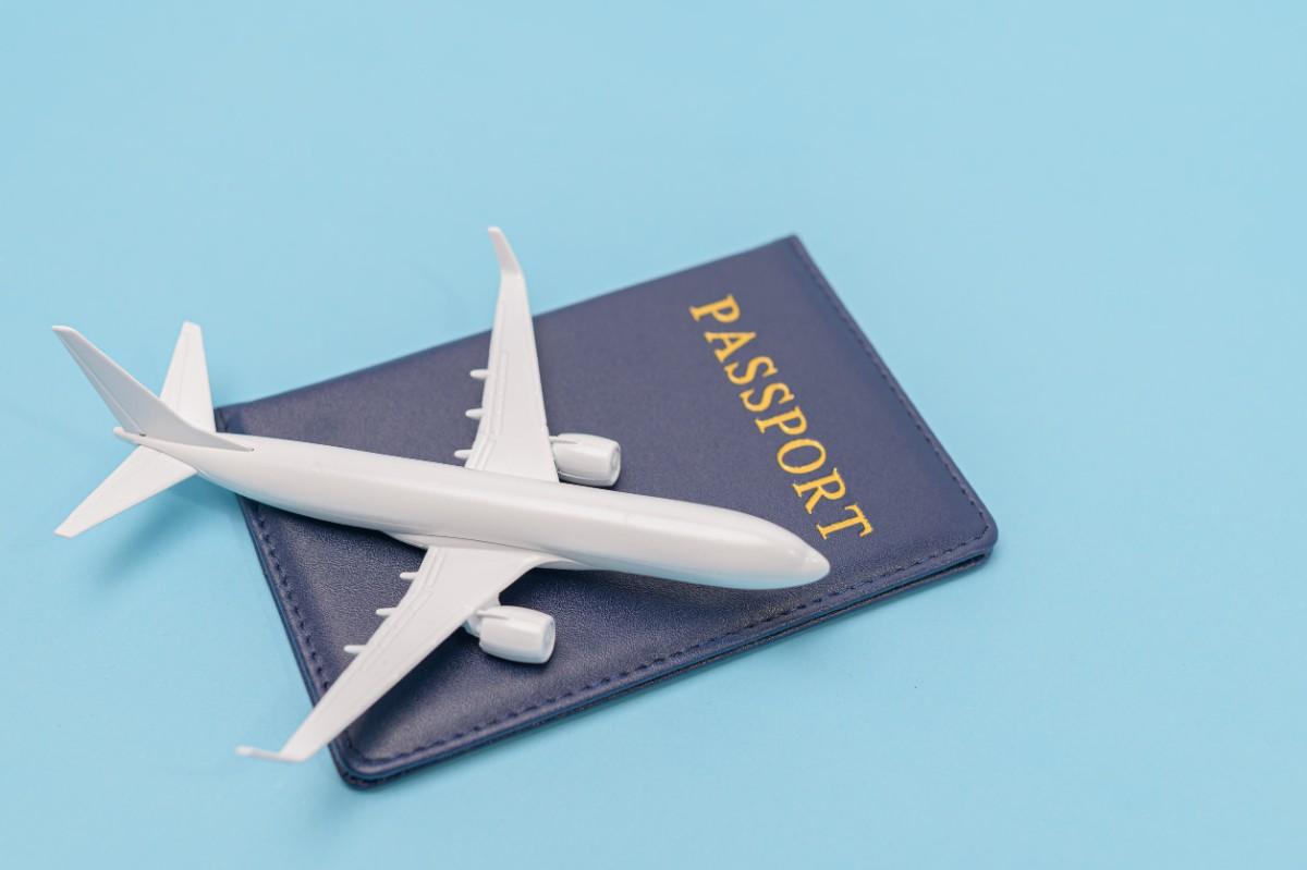 Passport And Airplane On Blue Background